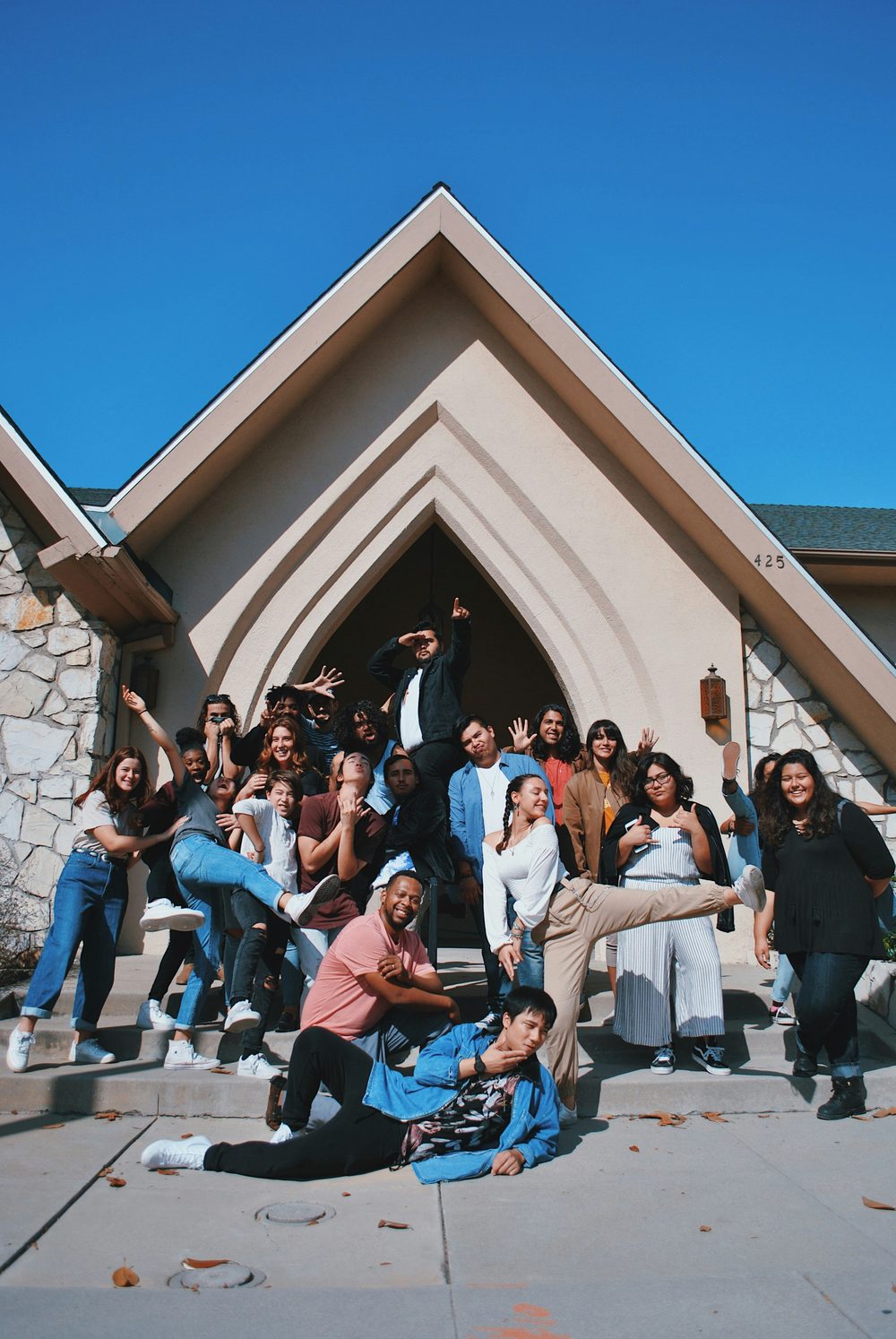 A group of people posing together outdoors near base.